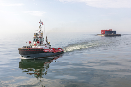 ASD tug Waterstraat tows cable reels to Eemshaven