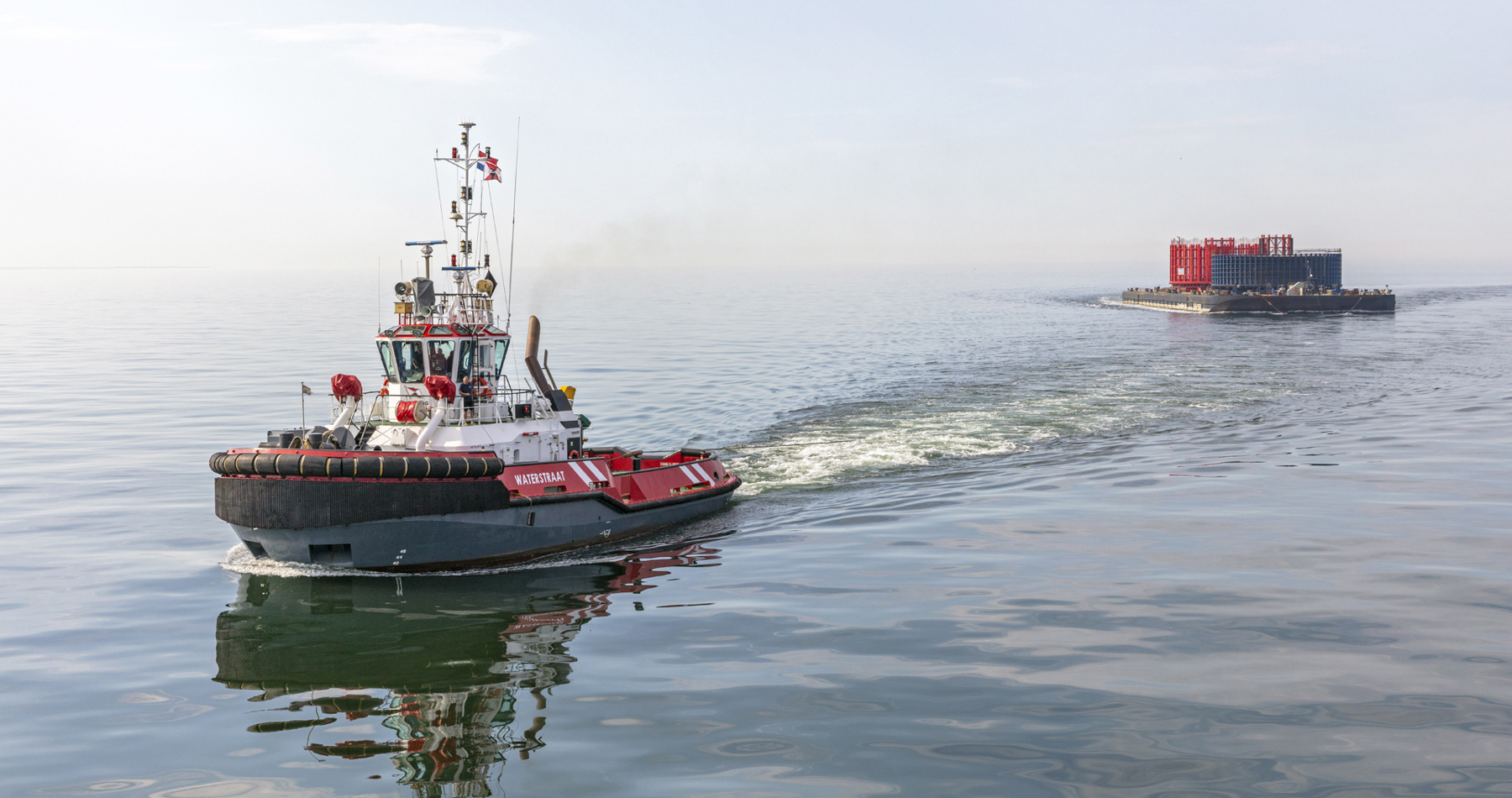 ASD tug Waterstraat tows cable reels to Eemshaven